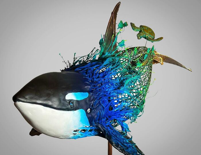Sculpture of an orca made from scrap metal showcasing striking animal sculptures by an innovative artist.