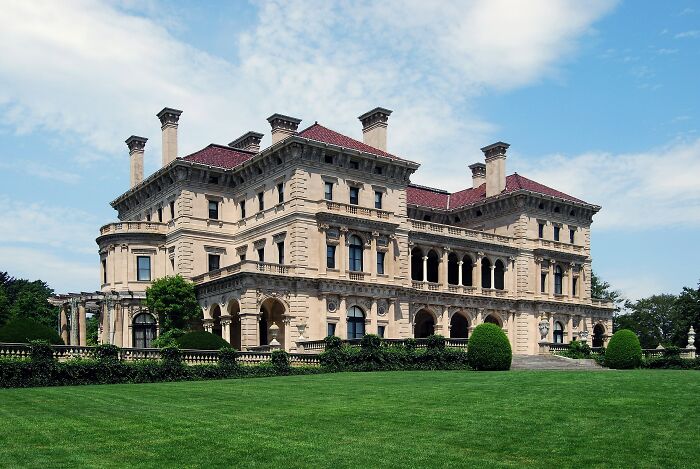 Historic grand home with ornate architecture and manicured lawn showcasing America's architectural heritage.