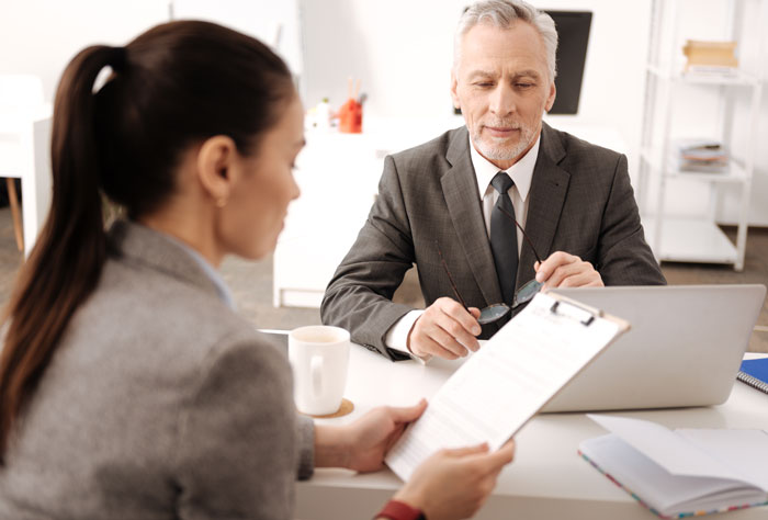 A woman discussing work and making reapply position options with a man during a professional interview meeting. A woman discussing work and making reapply position options with a man during a professional interview meeting.