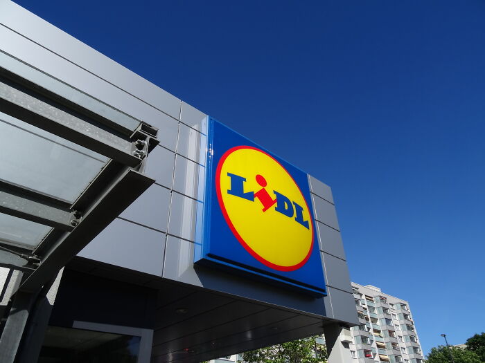 Lidl store exterior with bright logo on building under clear blue sky, highlighting public places where unusual things occurred.