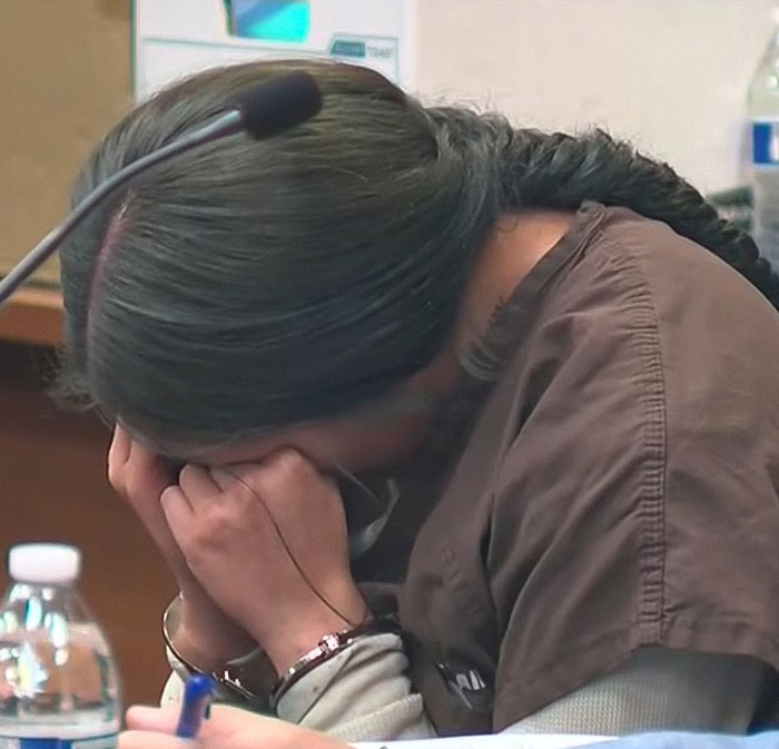 Woman in court sobbing with head in hands after baby lost his life in car during mom’s lip filler appointment.