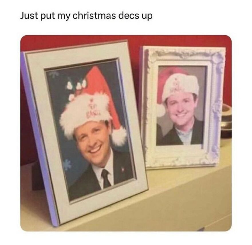 Two framed photos of men wearing Santa hats on a shelf, illustrating British humor and festive decorations meme.