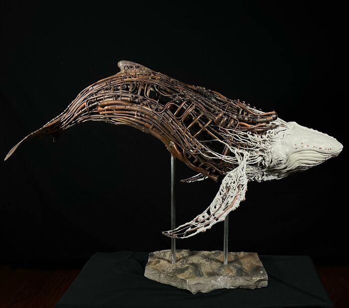Whale sculpture made from scrap metal showing striking animal sculpture craftsmanship with detailed openwork design.