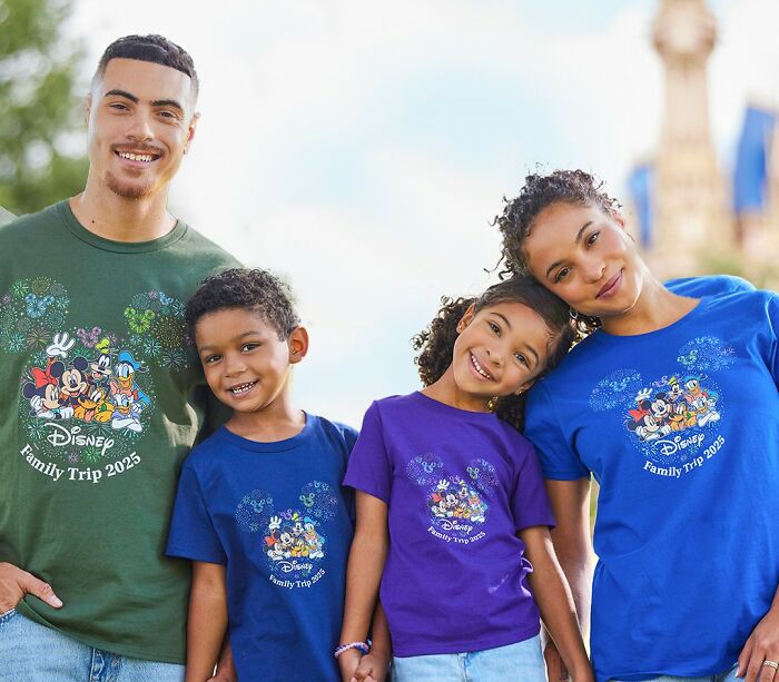 Family of four wearing Disney Family Trip 2025 shirts, smiling outdoors showing trends related to overconsumption concerns.
