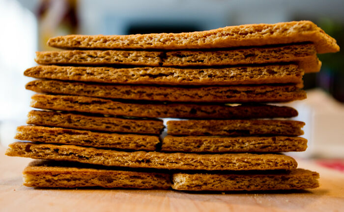 Stack of crispy rectangular crackers showcasing ingenious inventions that found new purposes over the years in modern kitchens.