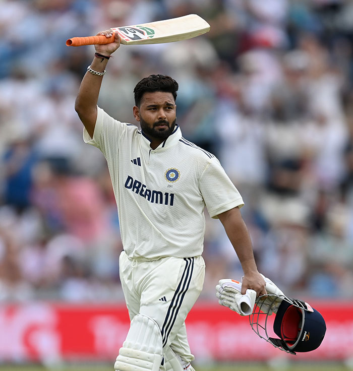 Top athlete on cricket field raising bat and helmet, mocked after interacting with fake influencer at Wimbledon event. Top athlete on cricket field raising bat and helmet, mocked after interacting with fake influencer at Wimbledon event.