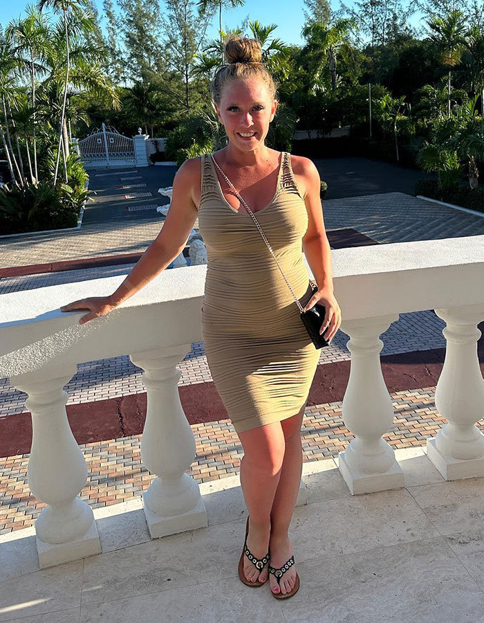 Young woman in a beige dress standing outdoors on a balcony, symbolizing mental health emergency in adult industry substance issues Young woman in a beige dress standing outdoors on a balcony, symbolizing mental health emergency in adult industry substance issues