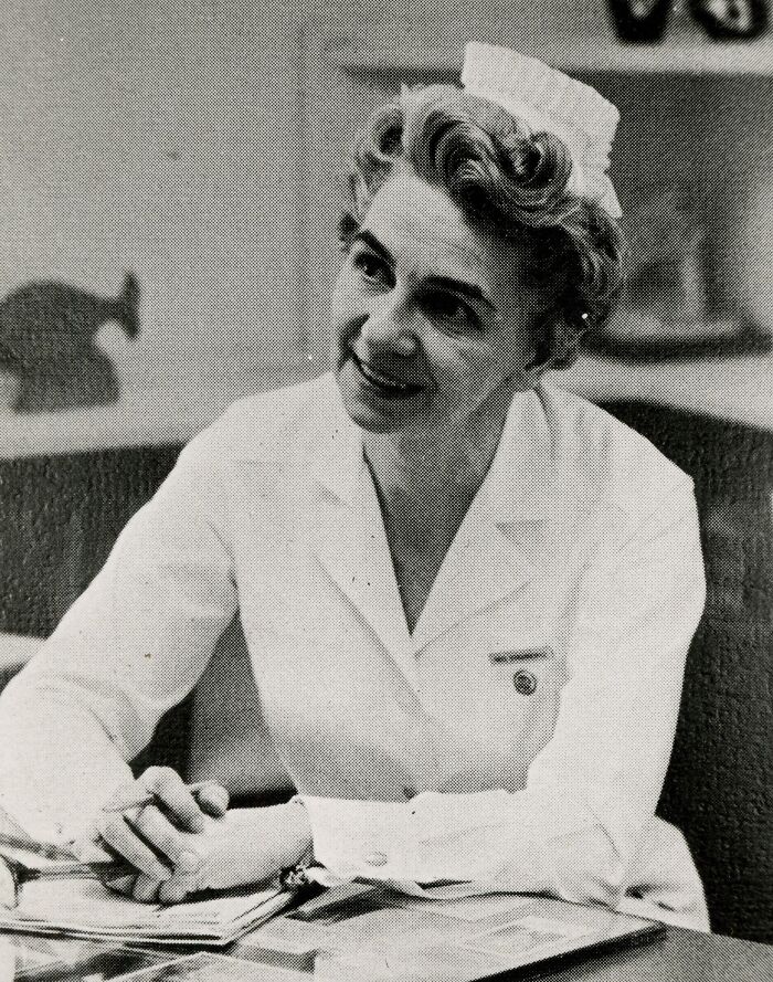 Vintage photo of a nurse in uniform smiling warmly, showcasing classic nursing style and compassionate care from past decades.