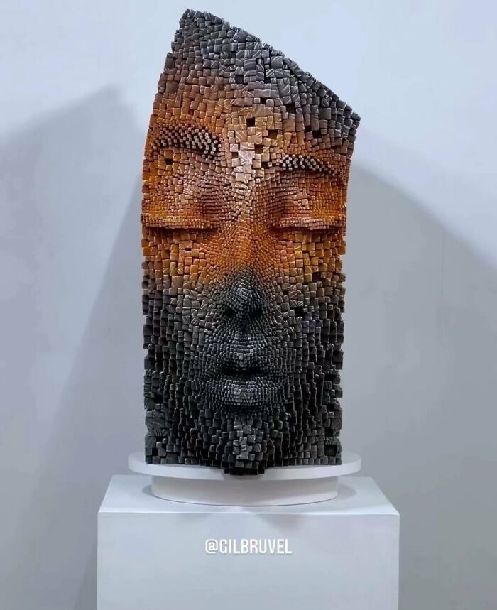 Wooden 3D face sculpture made of small sticks, creating a hypnotic and lifelike texture with detailed facial features.