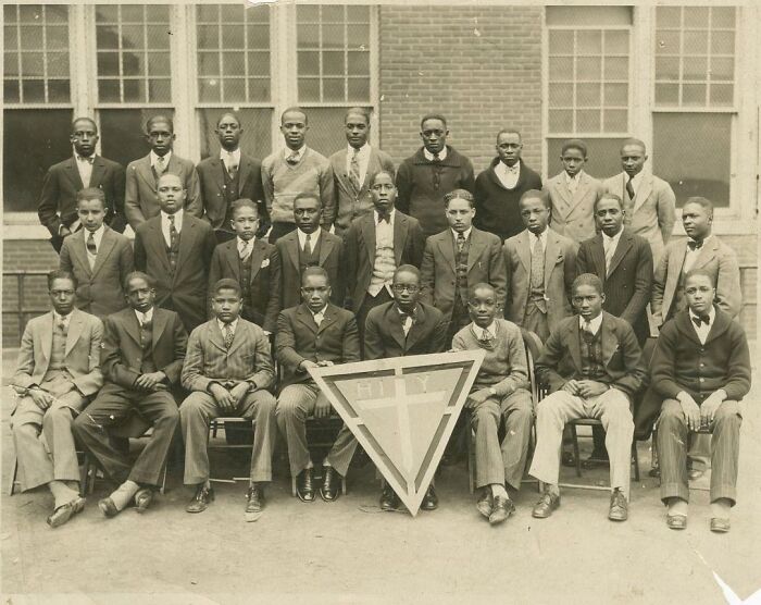 Group of men in suits posing for a vintage postcard photo capturing the heart of the 1930s in black and white.