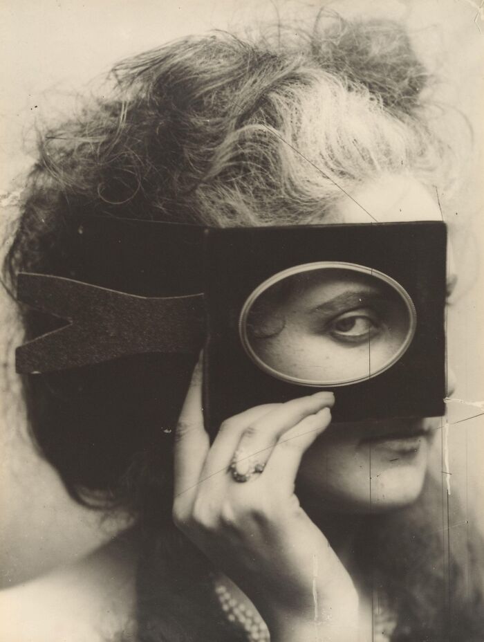 Vintage postcards featuring a 1930s woman with curly hair holding a frame to highlight her eye in black and white.