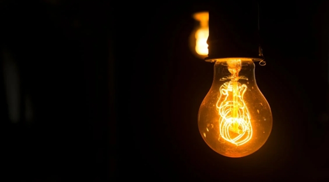 Glowing incandescent light bulb illustrating general science knowledge and unit used to measure electric current concept.