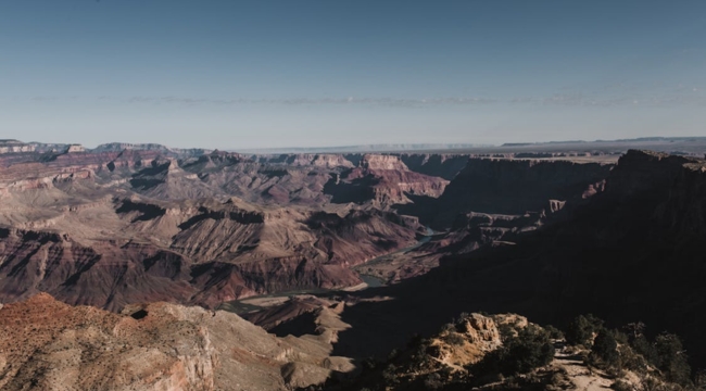 Vast rocky landscape of the Earth’s crust under clear sky, illustrating the layer of the Earth we live on.