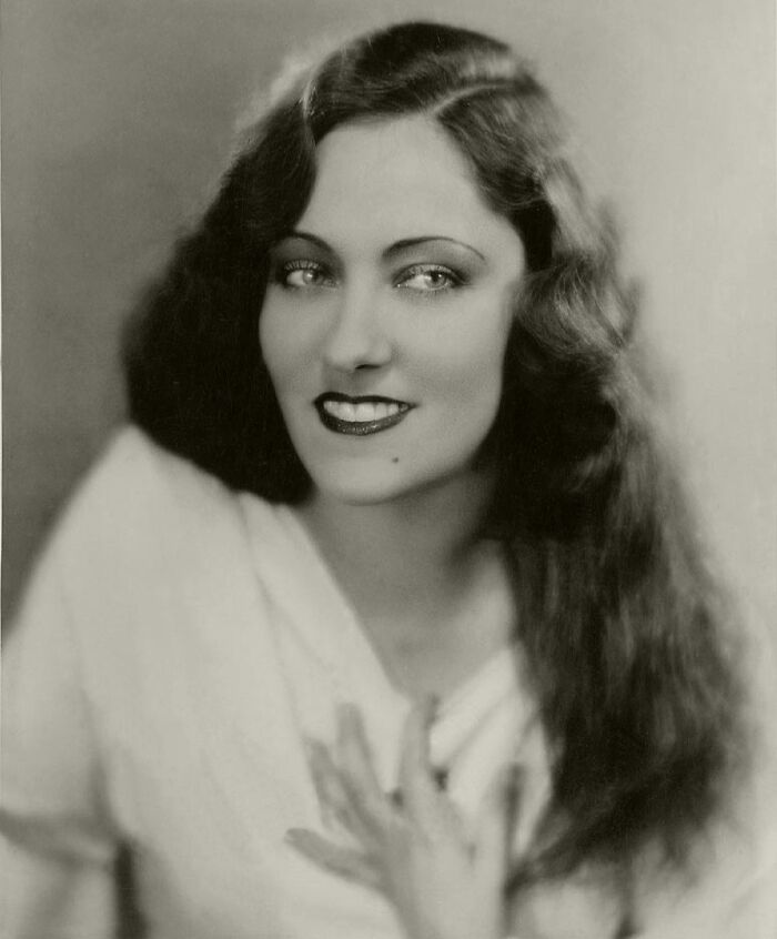 Vintage portrait of a woman showcasing timeless beauty with classic hairstyle and elegant expression from century-old photos.