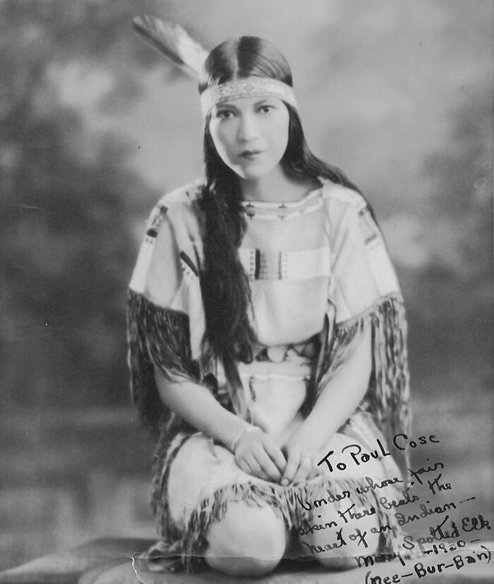 Vintage portrait of a woman in traditional attire, representing century-old photos of women with timeless beauty.