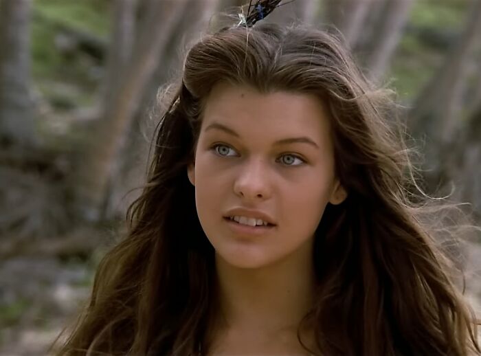 Young woman with long hair in a forest scene from one of the cinematic crimes and worst movie sequels of all time.