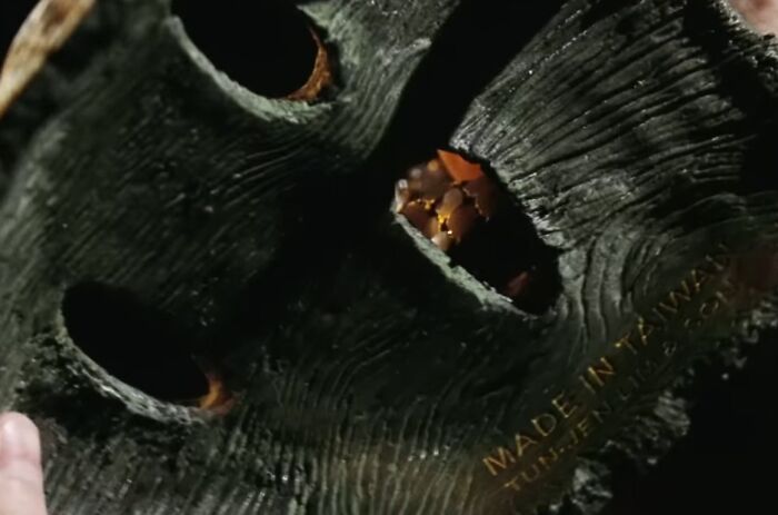 Close-up of a worn, creepy mask with hollow eyes, representing cinematic crimes in the worst movie sequels of all time.