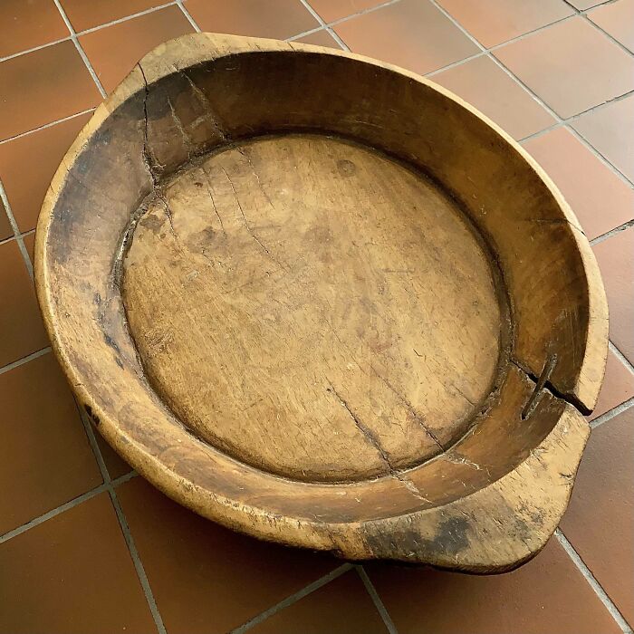 Old wooden bowl with visible cracks and wear, showcasing one of the most interesting and beautiful old things people own