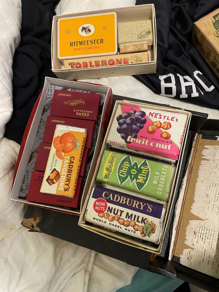 Vintage old chocolate bars including Cadbury's and Nestle's collectible packaging in a box, showcasing beautiful old things.