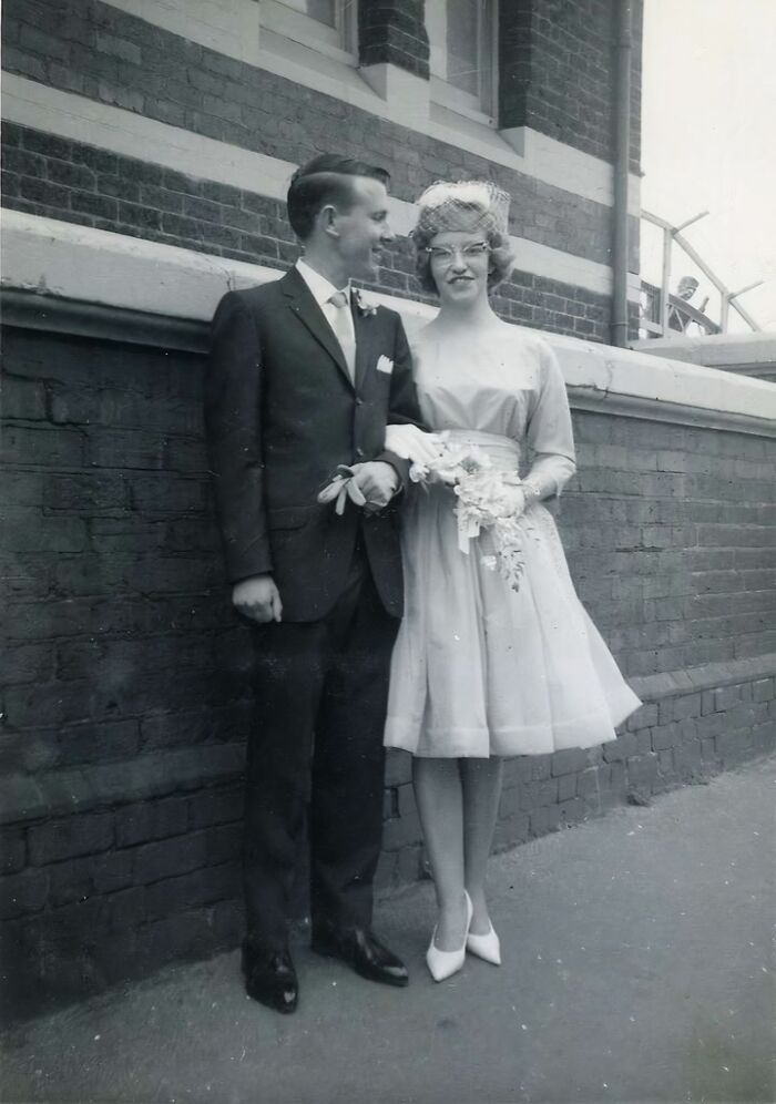 Black and white photo of a 1950s couple dressed for a formal event, showcasing daily life across the globe in the 50s.