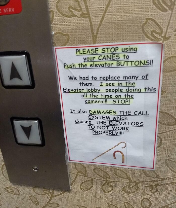 Elevator buttons next to a warning sign about people using canes causing damage, showing unbothered behavior.