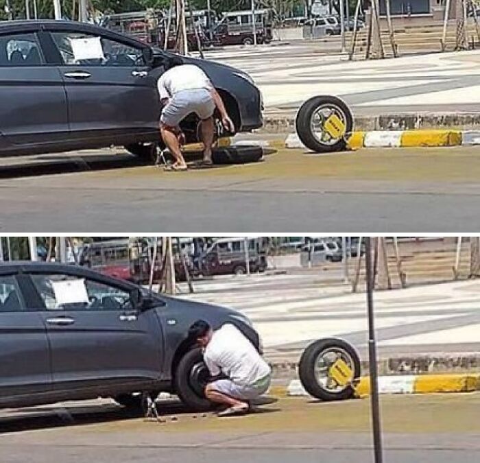 Man changing a car tire while the locked wheel remains attached, showing a suspiciously unbothered attitude outdoors.