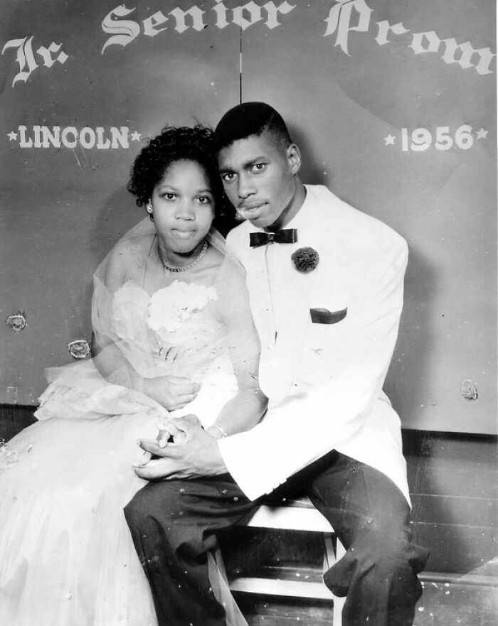 Couple dressed for 1956 senior prom, capturing daily life and fashion across the globe in the 50s.