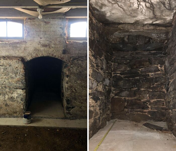 Dark stone cellar with a narrow entrance under old floor boards in an old home discovery of a fossil site.