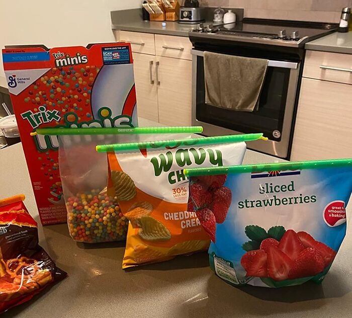Reusable bag clips sealing snack and frozen food bags on a kitchen counter, showcasing brilliant kitchen items.