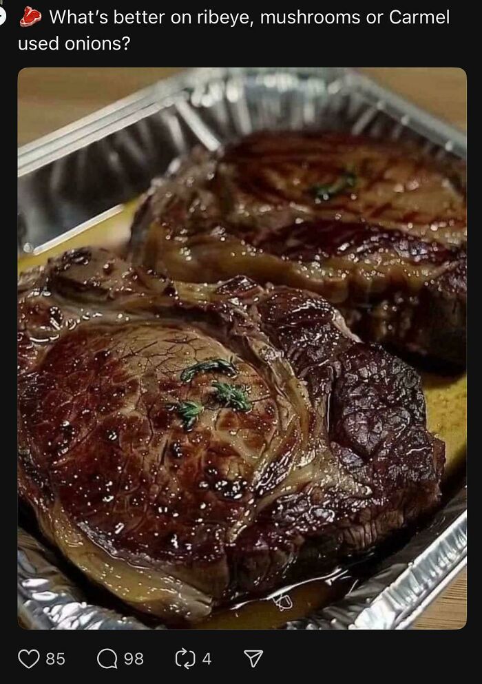 Two cooked ribeye steaks in a foil tray with herbs, illustrating a common typo about caramelized onions.