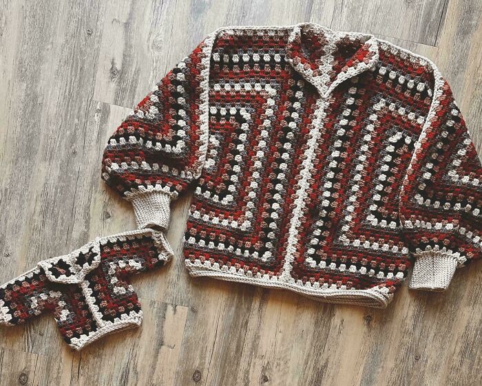 Crochet enthusiasts crafted matching adult and baby sweaters with intricate patterns in earthy tones, showcasing incredible skills.