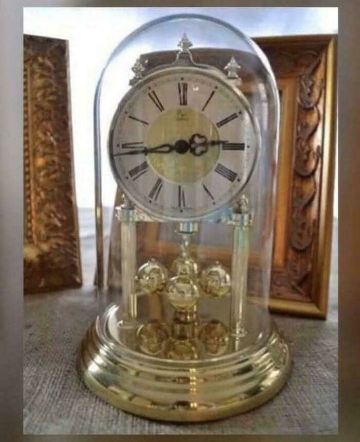 Antique anniversary clock with glass dome and gold detailing, a nostalgic piece for people realizing they’re old now