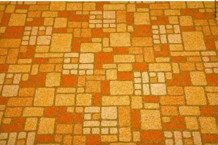Retro patterned floor tiles in orange and beige tones, evoking nostalgic pics of people realizing they're old now.