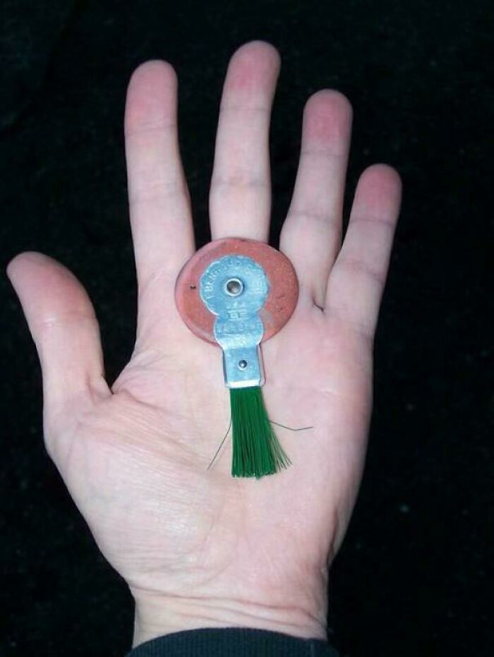 Hand holding a nostalgic vintage brush toy, evoking memories from people who just realized they’re old now.