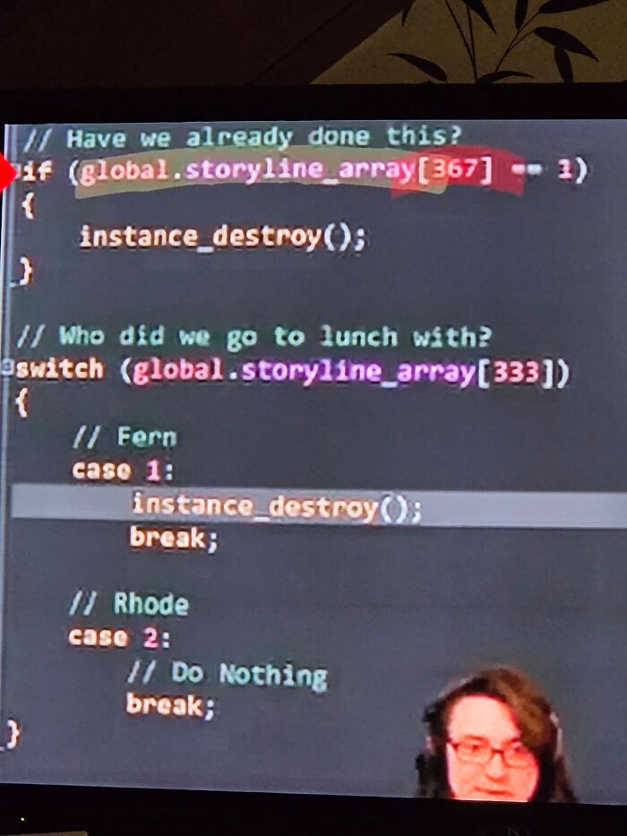 Programming code snippet on a screen with highlighted global storyline array and a person wearing glasses in the corner.