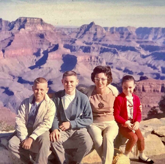 Vintage family photo at Grand Canyon capturing candid glimpses into the past with natural smiles and retro clothing styles.