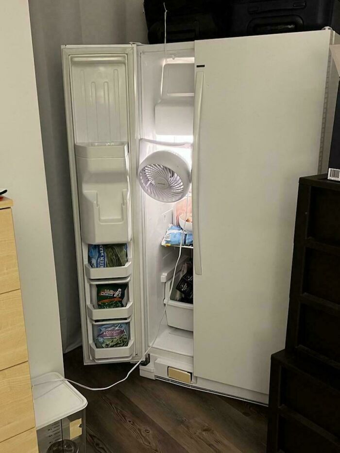Refrigerator with a fan hanging inside to circulate cold air, an inventive redneck engineer creation.