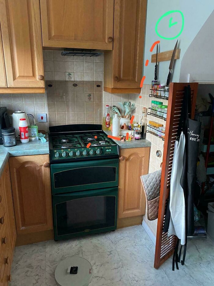 Coincidence of kitchen stove knobs all pointing down with spice rack knives aligned, captured in a cozy kitchen setting.