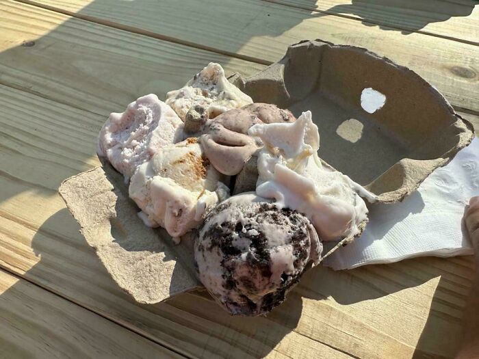 Several molds of ice cream served in a broken egg carton, showcasing one of the most ridiculous food presentations in restaurants.