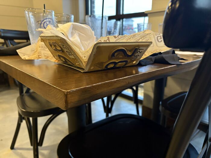 Serving food in a restaurant using a folded license plate as a unique and ridiculous serving tray.