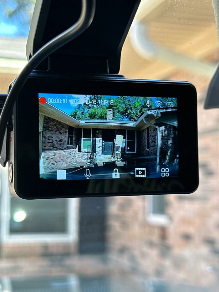 Car dash cam showing video recording of a brick house entrance, highlighting top Prime Day electronic deals.