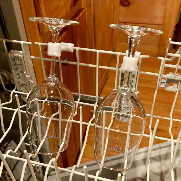 Wine glass holders secured to dishwasher rack, showcasing innovative kitchen items worth the counter space.