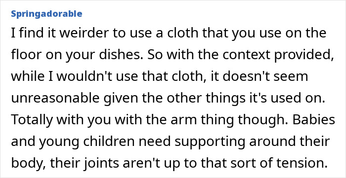 Husband carries infant by the arms and wipes face with dishrags, wife concerned about baby’s safety and hygiene. Husband carries infant by the arms and wipes face with dishrags, wife concerned about baby’s safety and hygiene.