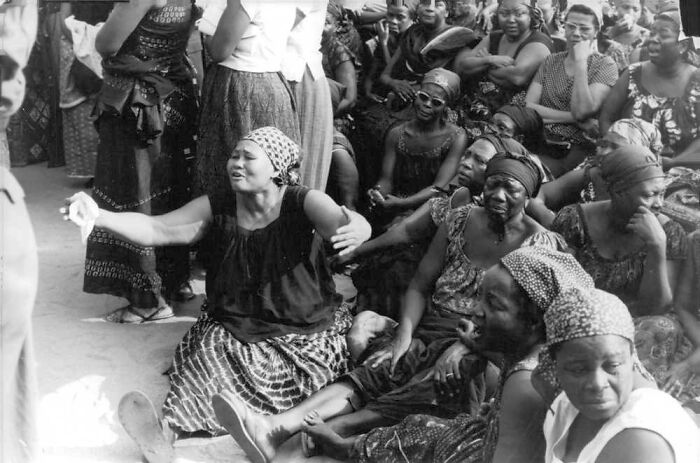 Group of women in traditional attire expressing grief, a somber photo capturing a gut-wrenching moment from history.