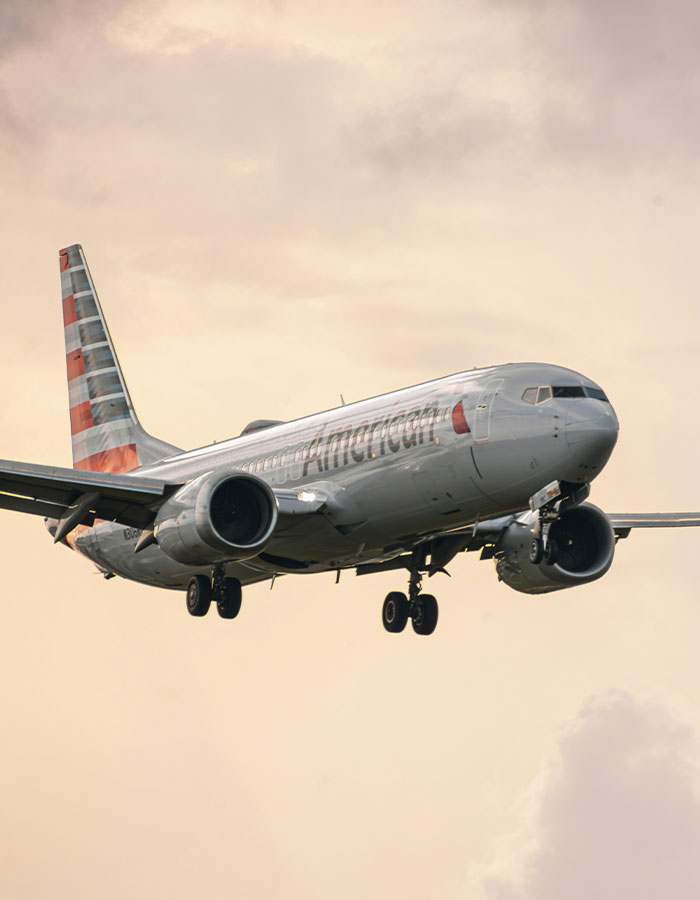 Passenger sparks scare on flight causing emergency landing, with airplane descending against cloudy sky background. Passenger sparks scare on flight causing emergency landing, with airplane descending against cloudy sky background.