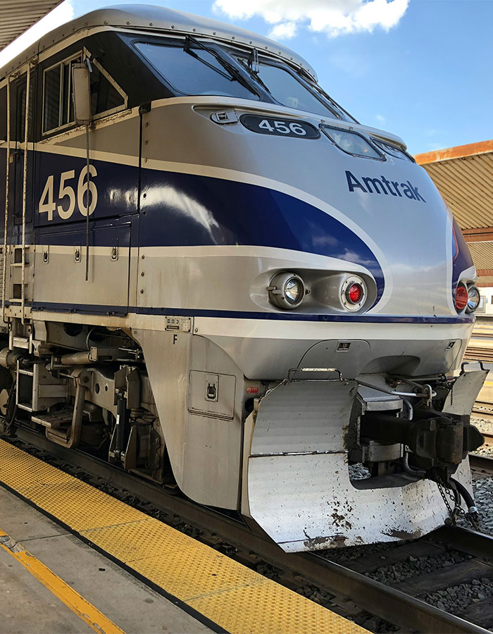 Amtrak train 456 standing at station platform under blue sky during daytime travel scene. Amtrak train 456 standing at station platform under blue sky during daytime travel scene.