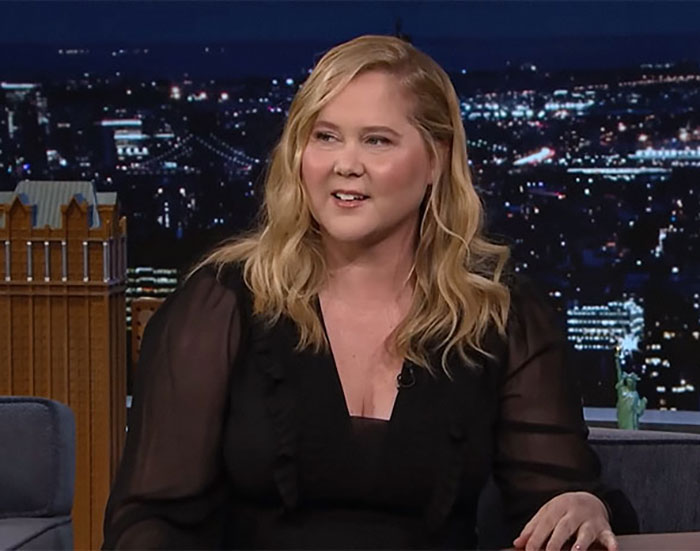 Comedian Amy Schumer with blonde hair and black blouse, sharing about new weight loss jab after Ozempic issues on TV show. Comedian Amy Schumer with blonde hair and black blouse, sharing about new weight loss jab after Ozempic issues on TV show.