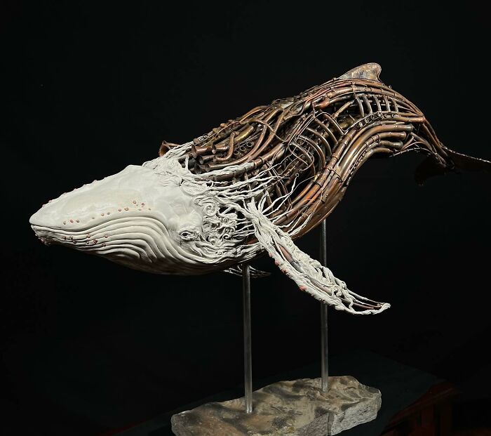 Whale sculpture made from scrap metal showing striking animal sculpture craftsmanship with detailed openwork design.