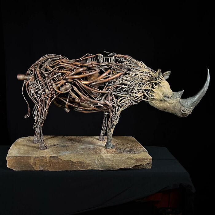 Rhino sculpture made from scrap metal pieces showcasing detailed and striking animal art by recycled materials artist.