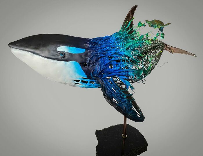 Sculpture of an orca made from scrap metal showcasing striking animal sculptures by an innovative artist.